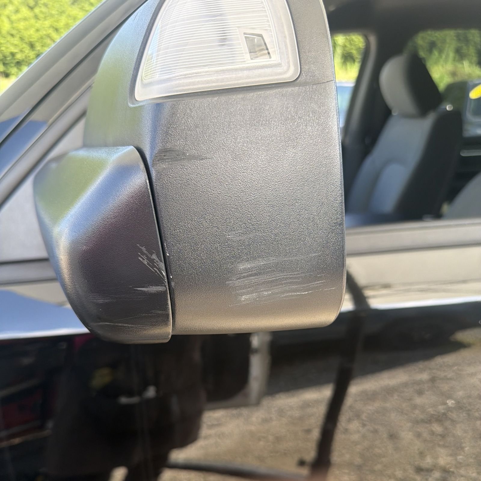 Close-up of scratches on a Dodge Ram mirror housing