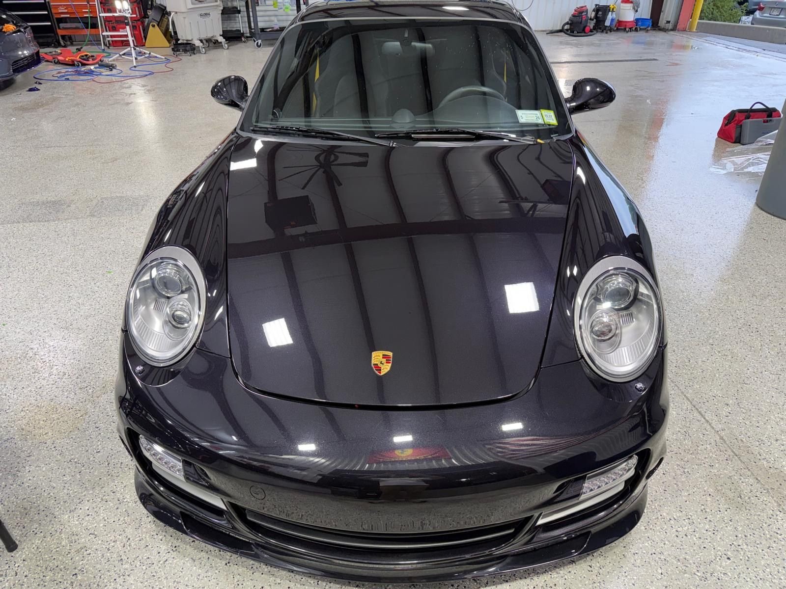 Glossy black Porsche 911 with a deep reflective finish
